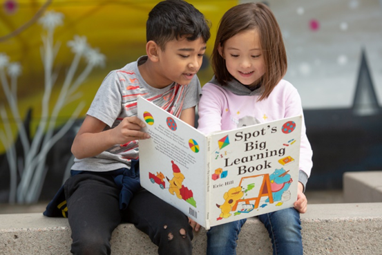 Young students reading a book